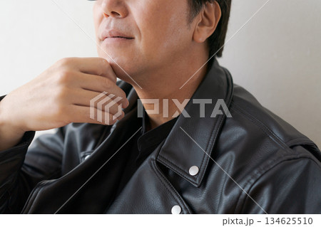メガネをかけて革ジャンを着た50代男性 メガネをかけて革ジャンを着た50代男性 134625510