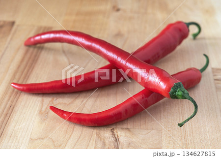 Chilli pepper on the wooden surface 134627815