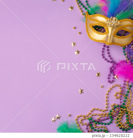 Mardi Gras and fat Tuesday background. Festive decorations on a lilac background Mardi Gras and fat Tuesday background. Festive decorations on a lilac background 134628222