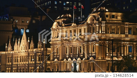 Shanghai, China. China Merchants Bank Building and Great Northern Telegraph Building at night time. iconic view of Shanghai's waterfront filled with bustling life and luminous architecture at night 134628514