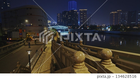 Night Payoff with Riverside Pathway and Vibrant Cityscape Reflections 134628516