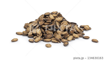Pile of dried watermelon seeds on white background Pile of dried watermelon seeds on white background 134630163