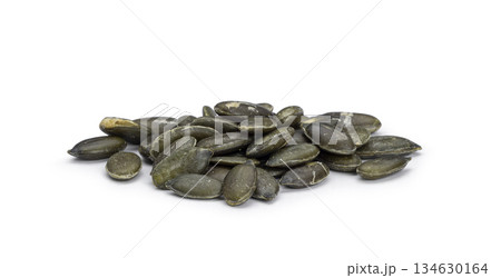 Pile of organic hulled pumpkin seeds on white background 134630164