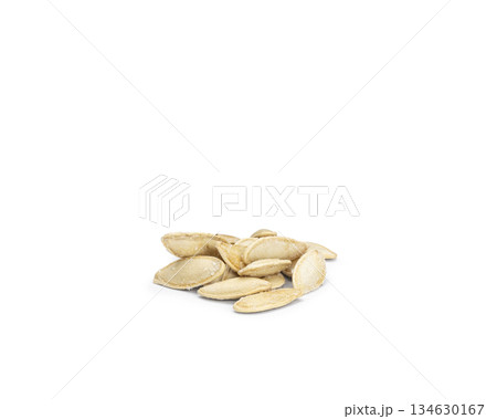 Pile of roasted salted pumpkin seeds on white background 134630167