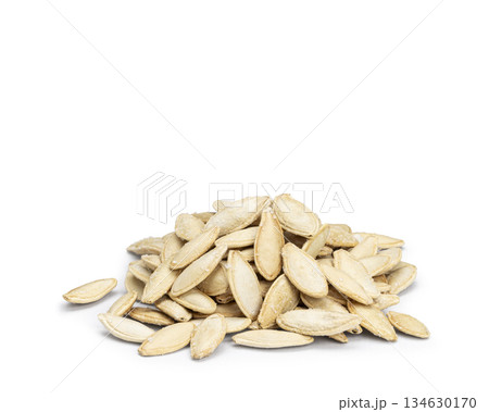 Pile of roasted salted pumpkin seeds on white background Pile of roasted salted pumpkin seeds on white background 134630170