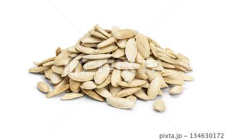 Pile of roasted salted pumpkin seeds on white background 134630172