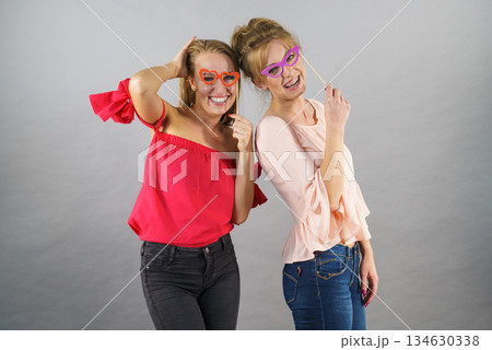 Women with party decoration mask stick glasses 134630338