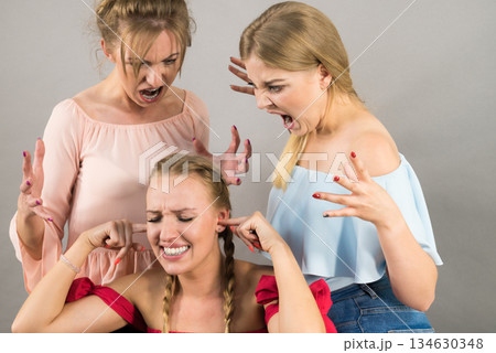 Woman being bullied by two females Woman being bullied by two females 134630348