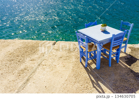 Open cafe outdoor restaurant in Greece on sea shore 134630705