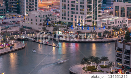 Luxury Dubai Marina canal with passing boats and promenade day to night timelapse, Dubai, United Arab Emirates Luxury Dubai Marina canal with passing boats and promenade day to night timelapse, Dubai, United Arab Emirates 134631253