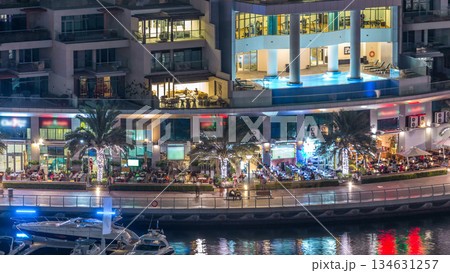 Luxury Dubai Marina canal with passing boats and promenade night timelapse, Dubai, United Arab Emirates Luxury Dubai Marina canal with passing boats and promenade night timelapse, Dubai, United Arab Emirates 134631257