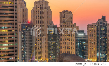 Dubai marina and JBR towers panorama day to night timelapse lights turn on. Dubai marina and JBR towers panorama day to night timelapse lights turn on. 134631289