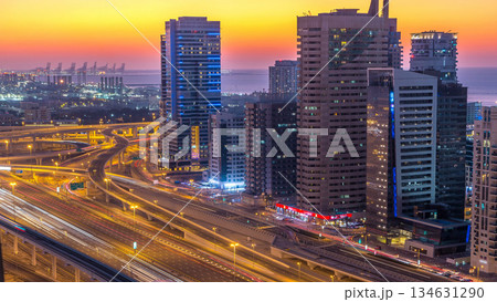 Dubai marina with traffic on sheikh zayed road panorama day to night timelapse lights turn on. Dubai marina with traffic on sheikh zayed road panorama day to night timelapse lights turn on. 134631290