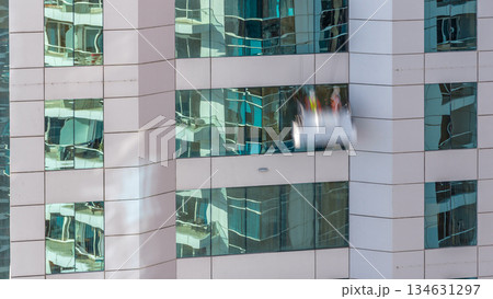 Washers wash the windows of modern skyscraper timelapse 134631297