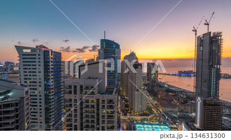 JBR and Dubai marina after sunset aerial day to night timelapse JBR and Dubai marina after sunset aerial day to night timelapse 134631300