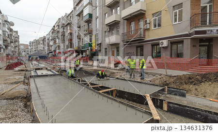 Concrete works for road maintenance construction site with many workers and mixer timelapse 134631376