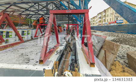 Tram rails at the stage of their installation and integration into concrete plates on the road timelapse hyperlapse. Tram rails at the stage of their installation and integration into concrete plates on the road timelapse hyperlapse. 134631383