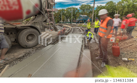 Concrete works for road construction with many workers and mixer timelapse hyperlapse 134631384