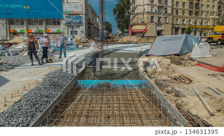 Concrete works for road construction with many workers and concrete pump timelapse 134631395