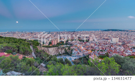 View of Barcelona day to night timelapse, the Mediterranean sea, The tower Agbar and The twin towers from Bunkers Carmel. Catalonia, Spain. 134631477