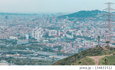 Barcelona and Badalona skyline with roofs of houses and sea on the horizon at evening timelapse Barcelona and Badalona skyline with roofs of houses and sea on the horizon at evening timelapse 134631512