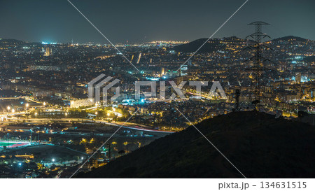 Barcelona and Badalona skyline with roofs of houses and sea on the horizon night timelapse Barcelona and Badalona skyline with roofs of houses and sea on the horizon night timelapse 134631515