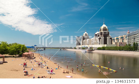 People are bathing in a river along an artificial beach timelapse hyperlapse and skyline of Astana, Kazakhstan 134631573