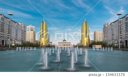 A square in front of Ak Orda with yellow towers timelapse hyperlapse and fountain in the foreground. 134631578