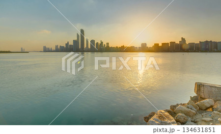 Abu Dhabi city skyline on sunrise time with water reflection timelapse. 134631851
