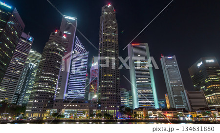 Singapore quay with tall skyscrapers in the central business district on Boat Quay night timelapse hyperlapse 134631880