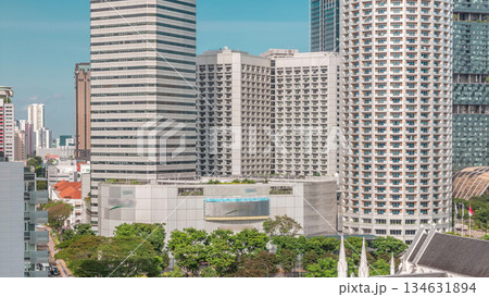 Skyscrapers near St. Andrew's Cathedral aerial timelapse. It is an Anglican cathedral in Singapore, the country's largest cathedral. 134631894
