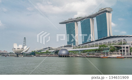 Fifty-five storeys high Marina Bay Sands Hotel dominates the skyline at Marina Bay in Singapore timelapse hyperlapse. 134631909