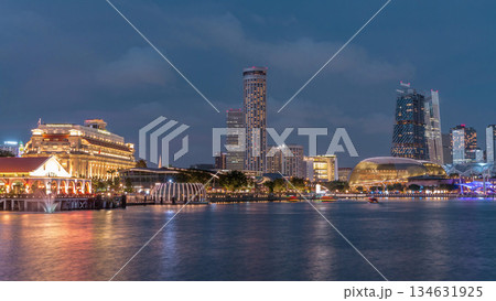 City skyline with skyscrapers and Esplanade Theatres on the Bay in Singapore at dusk, with beautiful reflection in water day to night timelapse City skyline with skyscrapers and Esplanade Theatres on the Bay in Singapore at dusk, with beautiful reflection in water day to night timelapse 134631925