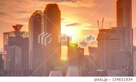 Sunset over the downtown skyline of Singapore as viewed from across the water from The Garden East timelapse. Singapore. 134631934