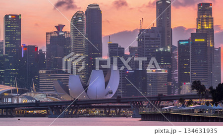 Downtown skyline of Singapore as viewed from across the water from The Garden East day to night timelapse. Singapore. Downtown skyline of Singapore as viewed from across the water from The Garden East day to night timelapse. Singapore. 134631935