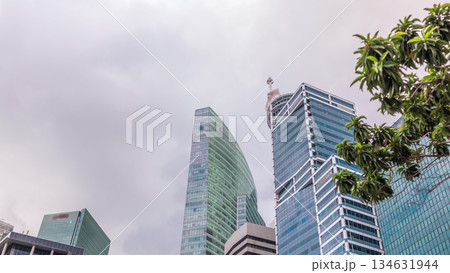 Looking up perspective of modern business skyscrapers glass and sky view landscape of commercial building in central city timelapse 134631944