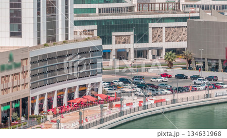 Parking near canal in Dubai at sunny day, UAE aerial timelapse Parking near canal in Dubai at sunny day, UAE aerial timelapse 134631968