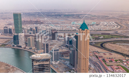 Panoramic aerial view of business bay towers in Dubai at evening timelapse. 134632017