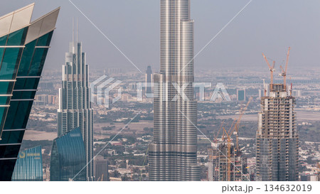 Panoramic aerial view of downtown towers from business bay in Dubai at evening timelapse. 134632019