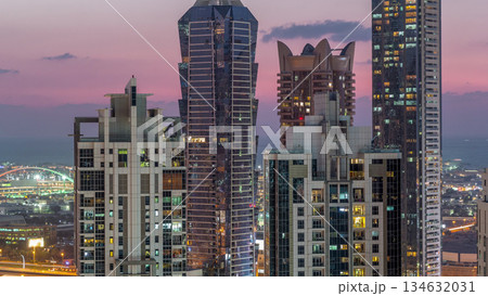 View of illuminated skyscrapers with lights from windows in Dubai at sunset aerial timelapse View of illuminated skyscrapers with lights from windows in Dubai at sunset aerial timelapse 134632031
