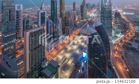 Skyline of the buildings of Sheikh Zayed Road and DIFC aerial day to night timelapse in Dubai, UAE. 134632100