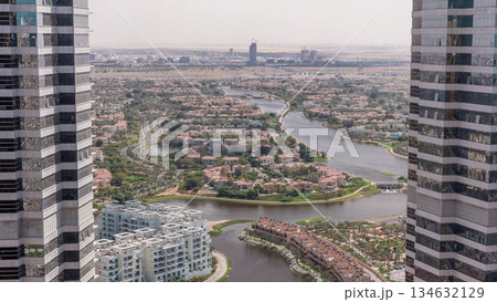 Aerial view of apartment houses and villas in Dubai city timelapse, United Arab Emirates 134632129