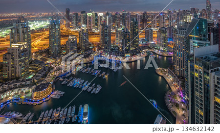 Dubai Marina skyscrapers and jumeirah lake towers view from the top aerial day to night timelapse in the United Arab Emirates. 134632142