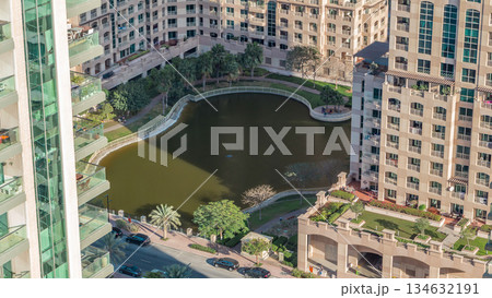 Manmade lake and residential buildings in Greens neighborhood timelapse in Dubai, UAE Manmade lake and residential buildings in Greens neighborhood timelapse in Dubai, UAE 134632191