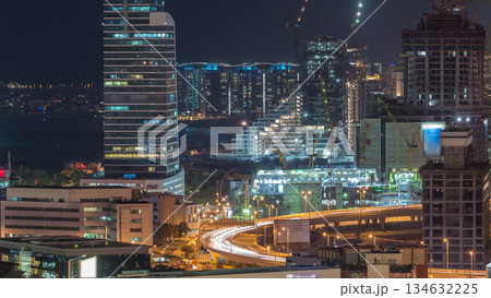 Dubai media city skyscrapers and construction site on palm jumeirah night timelapse, Dubai, United Arab Emirates Dubai media city skyscrapers and construction site on palm jumeirah night timelapse, Dubai, United Arab Emirates 134632225