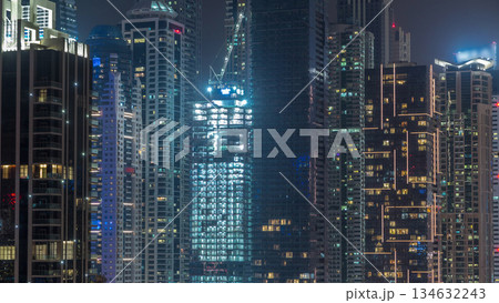 View of various skyscrapers and towers in Dubai Marina from above aerial night timelapse 134632243