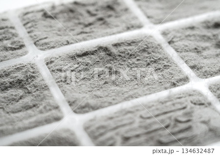 Dust covered filter surface with fiber structure and grid pattern. Air pollution buildup. Clogged filtration material 134632487
