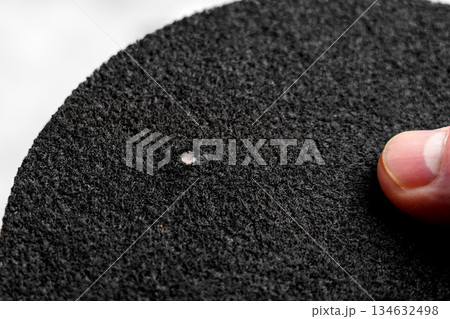 Hand holding water purification filter with fibrous texture and black rough surface Hand holding water purification filter with fibrous texture and black rough surface 134632498