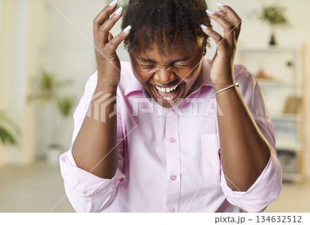 Stressed young African American woman crying overwhelmed with anger and frustration Stressed young African American woman crying overwhelmed with anger and frustration 134632512