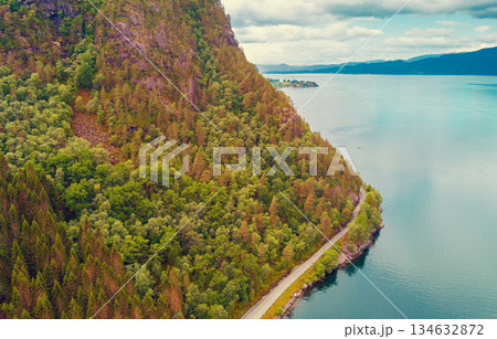 Fjord on a cloudy day. Rocky coast in the evening. Beautiful nature of Norway. Picturesque Scandinavian landscape. Norway, Europe 134632872